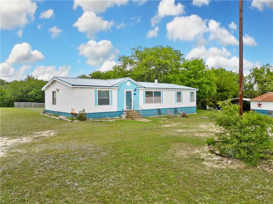 Welcome to 1890 Old Moody Road! This 3 bedroom, 2 bathroom home is situated on a sprawling 1.7 acre corner lot and provides the perfect combination of country living and city access (just minutes away from I35). You’ll be blown away by the breathtaking sunsets and how clearly you can see the stars at night! Inside the 1,568 sqft home you’ll find a generously sized living room with a beautiful fireplace, a spacious kitchen (refrigerator included), a separate laundry room (washer included), and a dining area perfect for family dinners. The primary suite is isolated from the other bedrooms and includes a double vanity, a separate shower, and a large tub. Back outside, you’ll enjoy a private setting with towering trees, a fenced area just off the back deck, an abundance of storage, and even a small basketball court! The property also has 5 covered parking spots. The “barn” includes 3 of those spots, a fully enclosed storage area or shop with power, and has been recently repaired, reinforced, and painted. Recent updates to the home include a brand-new HVAC system installed in 2022, fresh paint inside and out, new vinyl flooring throughout, new carpet in the bedrooms, updated electrical, new plumbing fixtures, and much more! Don’t miss out on this home that has so much to offer for such an affordable price! Book your viewing today!