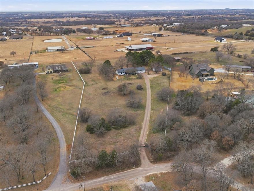 Welcome home to this beautifully remodeled 4-bedroom, 3-bath ranch-style home set on 4.3 private acres—offering the perfect balance of peaceful country living and close proximity to the city. With easy access to Cleburne amenities, shopping, and major routes, the location delivers both convenience and privacy.
A gated entrance welcomes you to a serene, nature-filled setting complete with a small wildlife pond and preserved native habitat. Inside, the flexible layout features two bedrooms with private full en-suite baths, including a spacious primary suite addition designed as a true retreat with a spa-inspired bath, Italian tile flooring, dual shower heads, and a custom walk-in closet with built-ins.
The updated kitchen showcases new appliances including a bar refrigerator, custom cabinetry, quartz countertops and backsplash, a custom pantry with slide-out drawers, and a new sink and disposal. New vinyl hardwood flooring extends throughout much of the home.
Additional upgrades include a dedicated gym with specialty flooring, two HVAC systems with updated ductwork, vinyl fencing, a metal garage building, chip-seal driveway, aerobic septic system, and an Eco Spa hot tub.
The land has been intentionally maintained to support wildlife with no recent chemical treatments, preserved mature trees, limited mowing, and multiple bird feeders—creating a peaceful retreat just minutes from town.