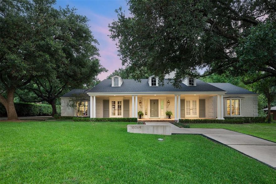 Stunning Hal Anderson one-story home, completely cosmetically updated. This 4-bedroom, 4-bath home is situated in quiet cul-de-sac on 1 acre lot in Preston Hollow. The curb appeal includes large, mature live oaks, landscaping, and a front porch with a lacquered door. Welcomed into spacious entry with gorgeous wallpaper, brick floors, wet bar, and adjacent plum colored living room with lacquered walls, french doors to front porch, fireplace, and built-ins. The dining room has floor-to-ceiling windows and seamless access to kitchen. The kitchen boasts marble countertops, Wolf cooktop, double oven, dishwasher, and  built-in refrigerator opens to breakfast room with charming wallpaper and bay windows. The oversized family room is nestled in center of home with a fireplace, wainscoting, wall of doors to backyard for indoor outdoor living, and a walk-in wet bar, that is fully wallpapered, featuring an ice-machine, beverage center, and built-ins.  A floor plan fit for the ultimate entertainer!  Right wing of home features the four bedrooms- primary suite with large bay windows, large walk-in custom closet, linen closet, separate vanities, bath & separate shower. Three guest bedrooms: two share jack-n-jill bath, built-ins & walk-in closets, and one bedroom with an ensuite bath & walk-in closet. Retreat to backyard on covered back patio & living area with views of pool, sport court  & grassy yard, mature trees. House completed with utility room & storage, 3-car garage with two additional detached bonus rooms with HVAC not included in the SF.