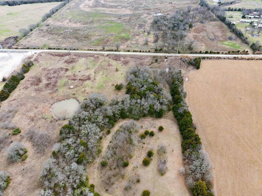 This diverse parcel of land combines the best balance of convenience and privacy, making it an ideal location for a future home site. Situated less than half a mile from a major highway, commuters will enjoy easy access from the bustling DFW area or the charming amenities available in Bonham and its surrounding communities. The lot is partially wooded, featuring mature trees that provide natural shade and privacy while carving out a scenic view. A small creek meanders through the property, adding a peaceful and picturesque water feature that enhances its charm and natural element. With water and electricity available, this blank canvas allows you the freedom to design and construct the home you've always envisioned. Additionally, you will benefit from close proximity to the new Bois D'Arc Lake, the future Ralph Hall Lake, and plenty of public land, which will enhance your outdoor recreation options. This is not just a piece of land; it's a gateway to a life of adventure and tranquility!