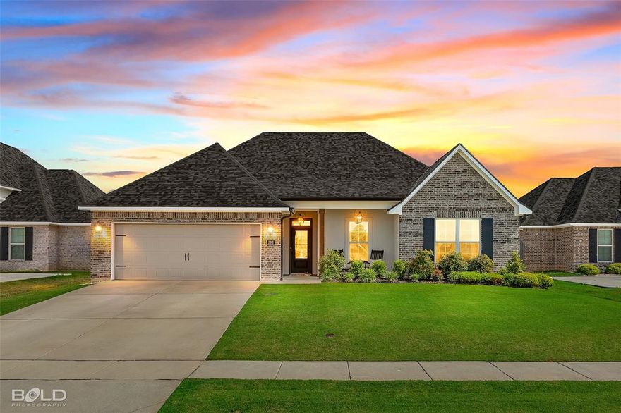 Welcome home to Lost River Estates! This CAMELLIA IV A open concept floor plan features 4-bedrooms, 2-bathrooms, 2,204 square feet and is ready for its new owners! The main living area features plenty of natural light, a gas fireplace complete with granite surround, and flows seamlessly to the kitchen, creating a functional space for everyday living as well as gatherings and entertaining. The kitchen features stainless appliances, upgraded granite countertops, 5 burner gas range, generous counter space, a large island and a walk-in pantry that provides exceptional storage. This home also has a whole home water softener system with a carbon filter for added peace of mind. The spacious primary suite is designed to offer both comfort and privacy, while the primary bathroom includes a large vanity with two sinks, relaxing soaking tub, custom tiled shower with frameless shower door, separate water closet, and a spacious walk in closet provides ample storage and organization. Three additional bedrooms provide flexible space for family, guests or working from home. Featuring ceramic wood look tile in the main areas and carpet in the bedrooms, as well as under mount sinks throughout, you’ll also have the added convenience of a smart connect Wi-Fi thermostat, upgraded paint, crown molding, LED lighting package throughout, LED pendant and recessed lights in the kitchen, tankless water heater, and Low E tilt-in windows. Enjoy outdoor living in the fully fenced backyard featuring a louvered pergola and composite wood decking, and is the ideal space for morning coffee or relaxing evenings at home. Enjoy the convenience of a two car garage and beautiful curb appeal, this move-in-ready home truly has it all and no detail was spared! Conveniently located near I-220, I-20, Barksdale Air Force Base, hospitals, shopping, dining, and within the highly sought-after Benton school district, this exceptional Benton home offers the ideal blend of location, condition, and lifestyle.