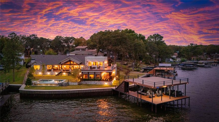Stunning and impeccable, this custom-built 2016 home offers over 172 feet of waterfront with sweeping, wraparound deep-water views in the highly sought-after Arnold Hills Estates. Designed for luxury living, nearly every room showcases panoramic water views. The home features reclaimed wood beams from Louisiana churches (circa 1890-1920), an open floor plan with walls of glass, real wood floors, and electric shades throughout. Offering 4 en suite bedrooms, the home includes 2 wet bars, 2 wine fridges, 4 gas fireplaces, and 3 living areas. Multiple outdoor spaces, including wraparound composite decks, patios, and balconies, provide the perfect setting for outdoor living and entertaining. A double-sided fireplace connects two spacious living areas, while the formal dining room and large breakfast area with a second fireplace offer additional spaces to gather. The kitchen is a chef's dream with a prep kitchen featuring a second dishwasher, 2-inch solid honed marble countertops, a large island with seating, and custom appliances, including a Wolf Range and Bosch Fridge. The game room comes complete with a third fireplace, wet bar, wine fridge, third dishwasher, and ice machine. The waterside primary suite boasts a fourth fireplace, sitting area, and luxurious ensuite bath with soaking tub, steam shower, and separate vanities. A flex room off the master offers space for an office, hobby room, or exercise area. The home also features a Sonos sound system inside and out. Outside, enjoy a large covered patio with an outdoor kitchen, Green Egg, and views of the saltwater infinity pool, fire pit, and more. The recently built composite deck boathouse offers automatic boat cover and lifts, a 26’ boat slip and PWC slip, Add'tl highlights include an epoxy-floored 3-car garage, ample parking, a 32-gigawatt whole-house generator, Rinnai tankless water heaters, 2x6 exterior walls. Reinforced engineered foundation with 13ft deep 138 piers.