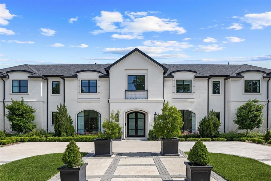 Discover refined elegance in this stunning Preston Hollow home, situated on an oversized 95x160 lot. Designed for both style and function, the open floor plan is enhanced by expansive arched windows, high-end finishes, and beautiful hardwood and marble floors. The main level features an incredible island kitchen with a Sub-Zero refrigerator and a Wolf 6-burner range, a generous guest suite, two spacious living areas, formal dining room, office, wet bar and pantry with a wine fridge, and laundry and mud rooms. Upstairs, you'll find a luxurious primary suite with its own living area, gym, massive walk-in closet, dual vanities, garden tub, and walk-in shower. 3 bedrooms with their own en-suite baths, a media room, and an additional utility room complete the second level. Step outside to a lovely backyard featuring a sparkling pool and an outdoor living area, perfect for entertaining or relaxing. Don't miss the opportunity to live in this exceptional home, walking distance to shopping and entertaining in Preston Royal Shopping Center.