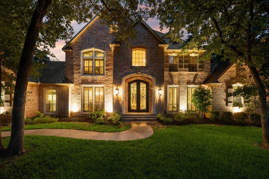 Unparalleled luxury and privacy await on 1.84 beautifully wooded acres in prestigious Argyle ISD. Situated just a short walk from Argyle Middle School, this custom estate exudes timeless elegance, masterful craftsmanship, and modern comfort. Built in 2012, the residence boasts 5 spacious bedrooms, 2 on the main level and 3 upstairs with a unique loft retreat, perfect for family living or multi generational needs. Enter through grand double iron doors into a soaring foyer adorned with custom tile work, rich hardwood floors, and exquisite architectural details. The expansive living area features dramatic ceilings, custom built ins, a striking fireplace, and a seamless flow into the gourmet kitchen and refined dining area, with wet bar designed for both upscale entertaining and everyday luxury. Upstairs, enjoy an oversized game room with a private balcony overlooking the pool, an elegant library, and a fully equipped two-level media room for an unparalleled cinematic experience. Step into your own resort style sanctuary, where a sparkling pool is nestled among mature trees, manicured gardens, and serene views. The outdoor space is crafted for entertaining and relaxation alike, featuring a tranquil fountain, extensive patio space, a charming arbor, and a dedicated dog run, all within a fully private shaded setting. Located in a top rated school district and filled with luxury finishes throughout, this extraordinary home offers a rare blend of elegance, comfort, and exclusivity, a true Argyle masterpiece.