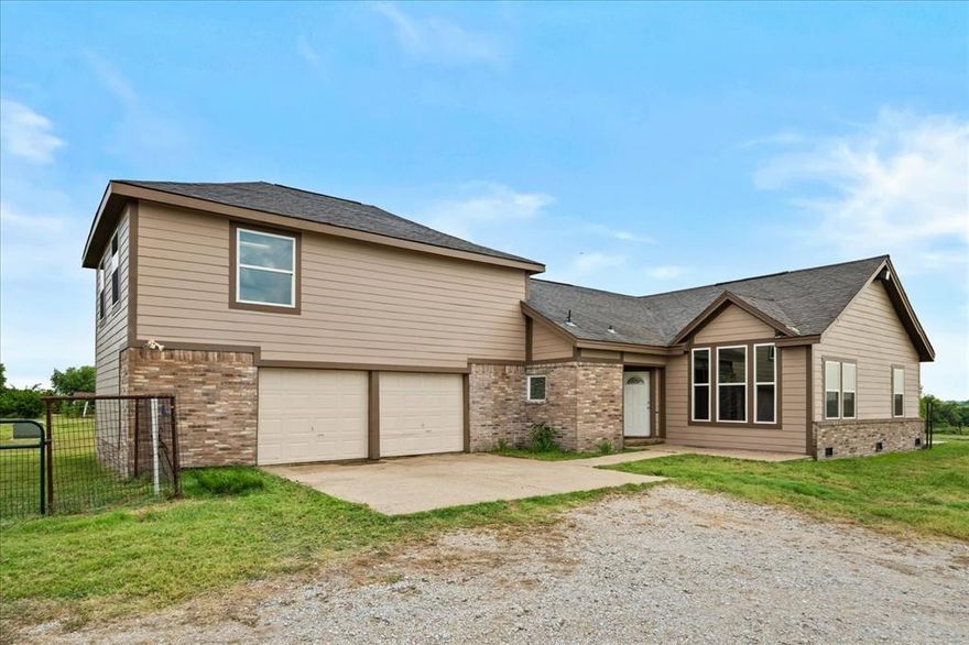 Enjoy the perfect blend of country living while still having city convenience with this beautiful 3 bed, 2 bath home recently remodeled in 2023 featuring all new windows, along with new roof being installed soon! Perched atop a gently sloping hill with nearly 5 acres along a well-maintained, low-traffic FM road, this property offers privacy, views, and peaceful surroundings—just minutes from shopping, restaurants, and other local amenities. Inside, you'll find a spacious living area with a cozy fireplace and a functional layout that includes a 2-car garage. Above the garage is a versatile loft space, perfect for a kids’ playroom, media room, or home office. Step outside to enjoy the covered back patio—ideal for relaxing or entertaining while overlooking your open acreage. The land is partially fenced and ready for horses, cattle, or any animals you’d like to bring along. A rare opportunity to enjoy the quiet of the country while staying close to town!