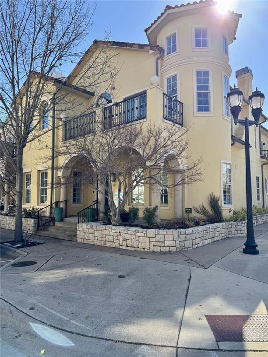 Located in the highly desirable Village at Colleyville, this corner-unit townhome combines luxury living with unbeatable walkability to shops and restaurants. Residents enjoy a community pool and fitness center, while the home itself impresses with soaring ceilings and thoughtfully designed living spaces. The gourmet kitchen is equipped with stainless steel appliances, a 6-burner KitchenAid gas cooktop, built-in double Frigidaire refrigerator, oversized island with natural stone countertops, and extensive storage. The main-level primary suite offers a private retreat with a spacious sitting area, patio access, jetted tub, and custom walk-in closet. Upstairs living includes a game room with fireplace, media room with wet bar and balcony, and a private office featuring rich wood built-ins and its own balcony. A second primary suite upstairs adds versatility for guests or multigenerational living. Conveniently located between Dallas and Fort Worth, minutes from the Dallas Fort Worth International Airport. Nearby Southlake Town Square and Historic Downtown Grapevine offer a multitude of shopping and dining options!