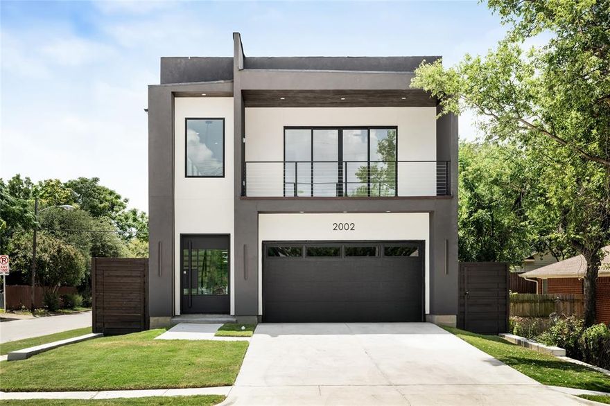 Stunning modern stucco home on a corner lot in the heart of Trinity Groves, offering luxury living just minutes from downtown Dallas. With 4 bedrooms, 3.5 bathrooms, and an open floor plan, this home is filled with natural light from soaring ceilings and expansive windows. The chef’s kitchen boasts a 48-inch gas range with pot filler, custom floating shelves with accent lighting, and a spacious walk in pantry. A glass enclosed wine display adds a designer touch. Upstairs you’ll find a game room, secondary living space, and access to an oversized covered balcony. Outdoor living is unmatched with a large backyard and a side-yard deck complete with grill connection, sink, and TV hookup—perfect for entertaining year-round. Located in the highly sought after Trinity Groves area, just under 8 minutes from downtown Dallas, this residence is designed for both comfort and style, combining luxury living with exceptional finishes and an unbeatable location.