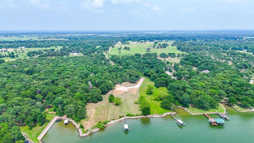 Experience true lake living on this 3.125-acre waterfront property on Richland Chambers Lake. With just under 300 feet of shoreline, this rare tract offers a beautiful mix of open space and mature trees, creating both privacy and flexibility for your ideal homesite. Enjoy direct water access with a private boat dock and boat ramp already in place, making it ready for immediate use or future development. The gently sloping terrain provides multiple build options for a custom home or weekend retreat. Expansive water views and a peaceful setting make this property stand out, while still offering convenient access to nearby roads and surrounding communities. With no HOA, you have the freedom to build and use the property to fit your vision. Whether you're looking to relax, entertain, or create your own lakefront escape, this property offers a rare combination of space, access, and setting.
