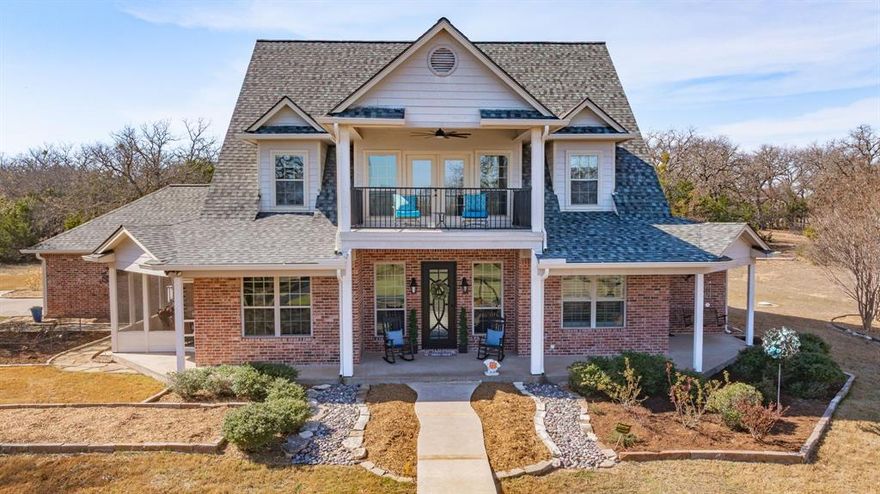 Experience elevated country living at 1218 Meander Road in Granbury. Set on approximately 5.04 scenic acres in Bentwater, this beautifully crafted two-story estate offers over 3,300 square feet of thoughtfully designed living space, blending timeless architecture with the serenity of wide-open Texas skies. Built in 2009, the home showcases expansive living areas, a stately fireplace, and a layout designed for both refined entertaining and everyday comfort. Natural light pours through generous windows, framing picturesque views of the surrounding acreage and private pond with a pier and fountain — a rare feature that enhances both beauty and tranquility. The outdoor living experience is exceptional. The backyard is enhanced by stunning professional landscaping and a tranquil water feature, creating a private retreat just steps from the home. The expansive back porch is designed for entertaining, complete with a fully equipped outdoor kitchen — ideal for hosting gatherings or enjoying quiet evenings under the Texas sky. Car enthusiasts and hobbyists alike will appreciate the total of four garage spaces, including an attached two-car garage and a separate detached two-car garage, offering flexibility for vehicles, storage, or workshop space. With privacy, acreage, refined finishes, and resort-style outdoor amenities, this property delivers a rare opportunity to own a truly distinguished Granbury estate.