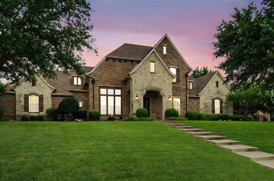 Nestled on approximately 0.75 acre in the prestigious Wyndemere community, this exceptional custom home offers the perfect blend of refined elegance, comfort, and upscale design. The thoughtfully crafted floor plan features a chef’s kitchen equipped with an oversized island, premium stainless steel appliances, 5-burner gas cooktop, wine chiller, spice pull-outs, and a large walk-in pantry. The open-concept family room is anchored by a beautiful custom fireplace and built-ins, ideal for everyday living and entertaining. The luxurious primary suite offers a spa-inspired bath and expansive walk-in closet, while a private guest suite on the main level adds convenience and versatility. Upstairs, two spacious bedrooms are accompanied by a private media room outfitted with a 4K projector, 7.2 surround sound system, and six power-adjustable theater chairs. The game room is designed for fun and function with a wet bar, mini fridge, and microwave. Elegant finishes throughout include extensive hardwood flooring, plantation shutters, rich millwork, and an oversized utility room with abundant storage. A three-car garage offers generous space and includes a Versa Lift system for effortless attic access. Outside, your private backyard oasis is framed by mature trees and lush landscaping. The resort-style pool and spa with waterfall are complemented by a recently added outdoor kitchen with built-in gas grill and bar. A stunning gazebo features a gas fireplace and mounted TV for year-round outdoor enjoyment. The Arctic Pool Chiller system ensures the water stays refreshingly cool during Texas summers. This extraordinary property offers luxurious living in one of the area’s most coveted communities.