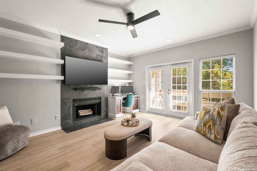 Stunning, fully renovated townhome-style condo in Lake Highlands, where modern design blends seamlessly with everyday comfort. This exceptional 2-bedroom, 2.5-bath residence has been thoughtfully updated from top to bottom, creating a truly move-in ready home. Recent upgrades include fresh neutral paint, 2in faux wood blinds, sliding barn doors for the laundry area, and new AC units. Step into a bright, open living room highlighted by luxury vinyl plank flooring, a striking floor-to-ceiling fireplace, and custom built-ins. Double doors lead to a private balcony with treetop views, while expansive windows fill the space with natural light. The kitchen showcases quartz countertops, stainless steel appliances, and a decorative tile backsplash. Upstairs, both bedrooms feature en-suite baths redesigned with modern finishes, elegant vanities, and designer tile for a spa-like retreat. The primary suite offers built-ins, dual sinks, and a frameless glass shower, while the secondary bedroom includes its own exterior entrance. This fabulous home is just steps from the community pool, and minutes from 635, shopping, and dining. A perfect blend of style, convenience, and comfort awaits.