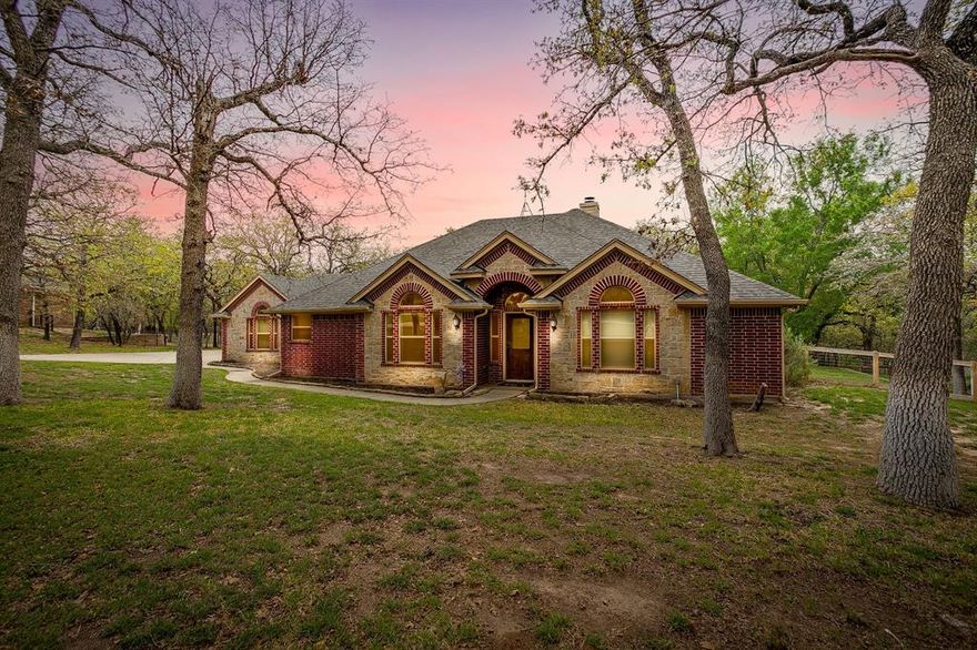 Excellent price in a prestigious neighborhood. GORGEOUS CUSTOM BUILT HOME on 2.01 acres with ABUNDANCE of mature trees! New Roof Sept 2025 Includes a study with French doors, rich walnut built-in cabinets, granite counters, stainless appliances, crown molding, stone WBFP, & dual tank water softener (Water Softener service March 2026). Hand scraped hardwood floors & tray ceiling in large living room. Master bath has a walk in shower, split vanities, and a separate jacuzzi tub, & two separate closets! Attic has 250 sf of floored storage space. R38 insulation, radiant barrier & six inch exterior walls. Large laundry room with sink! Excellent water well 15 gpm approx 245' deep. Seasonal creek & 4 ft cedar fence. Granite in kitchen and Marble in bathrooms. New AC in 2018! 7 zone sprinkler sys. & storage shed!  Additional upgrades include new water heater: March 2026, Tesla Charger installed February 2026, Starlink Internet, Ring Doorbell + Ring Floodlight camera, New Dishwasher Feb 2026, Oven (with air fryer + temp probe) Aug 2022 Microwave (can be used as a double oven) Oct 2022 and new paint in entryway and hallway March 2026.