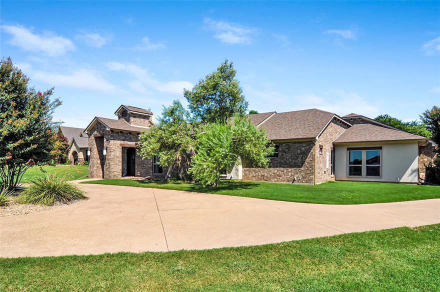 Motivated Seller — Priced Below Tax Value! This custom 2,978 sq ft single-story home truly has it all! Located just 30 minutes from Fort Worth, it’s perfect as a commuter retreat or luxurious weekend getaway. Situated on 1.25 beautifully landscaped acres, this 3-bedroom, 3.5-bathroom home features a 3-car garage, great covered front entry with a circular drive, and even a deeded boat slip in the nearby marina. Enjoy lake views right across the street!

Inside, you'll find soaring ceilings, great natural light, and a smart, flowing floor plan with solid-surface flooring throughout all main living areas. The spacious chef's kitchen features gas cooking, a breakfast bar, and ample workspace. The home is equipped with recently updated heating and air systems, hot water on demand, and a lifetime steel roof for added efficiency and peace of mind.

Out back, the private, park-like yard is your own personal oasis: a saltwater pool and spa, outdoor cabana with fireplace, and plenty of space to relax or entertain.

Don't miss your chance to own this rare combination of comfort, convenience, and luxury—schedule your private tour today!