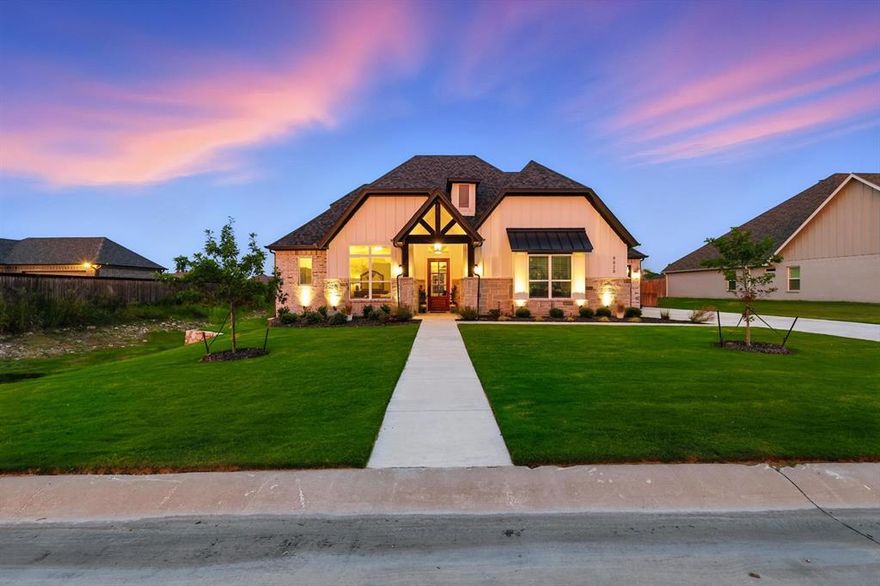 STUNNING 2023 custom farmhouse style home is a DREAM COME TRUE!  Shows even better in person, come see for yourself all of the stylish upgrades this home has to offer!  Located in Denton County, meet the best of both worlds, near the charming small-town atmosphere of Justin, combined with close proximity to the major metropolitan area of Dallas Fort Worth.  Situated on just over a half acre w loads of curb appeal incl board and batten siding and stone facade.  Welcome in through an entryway of solid hardwood floors that extend throughout the downstairs living areas and master suite.  Ideal floorplan features kitchen, living room, master suite, second bedroom w adjacent full bath, guest half bath, and laundry room all downstairs.  Upstairs includes a game room, two large bedrooms and a jack-n-jill bath w dual vanities.  Chefs kitchen boasts a massive gray toned, center island with built-in sink.  Beautiful white cabinets, with under cabinet lighting extend to ceiling providing plenty of storage space.  Note gracious granite countertops, subway tile backsplash, propane gas cooktop, gorgeous pendant lighting and stainless steel appliances including double ovens and microwave.  Plenty of seating at the kitchen island and in the the light filled breakfast nook.  Open concept great room features a wall of windows overlooking the oversized backyard, wrapped wood beams, stone accented propane gas fireplace w natural wood mantle, and built-in cabinetry.  Beautiful modern master bath includes separate vanities, glass enclosed shower w dual heads and bench seat, and stand alone tub.  Enjoy being outdoors on your extended back patio.  TONS of room to add a pool or ancillary buildings.  Full house water softener system w reverse osmosis to kitchen, fridge & laundry.  ***AFFORDABILITY is REAL! NO CITY TAXES and take advantage of LENDER PROVIDED 1-year temporary rate buydown, w potential savings up to $430 per month for the first year through listing agent's preferred lender! ***