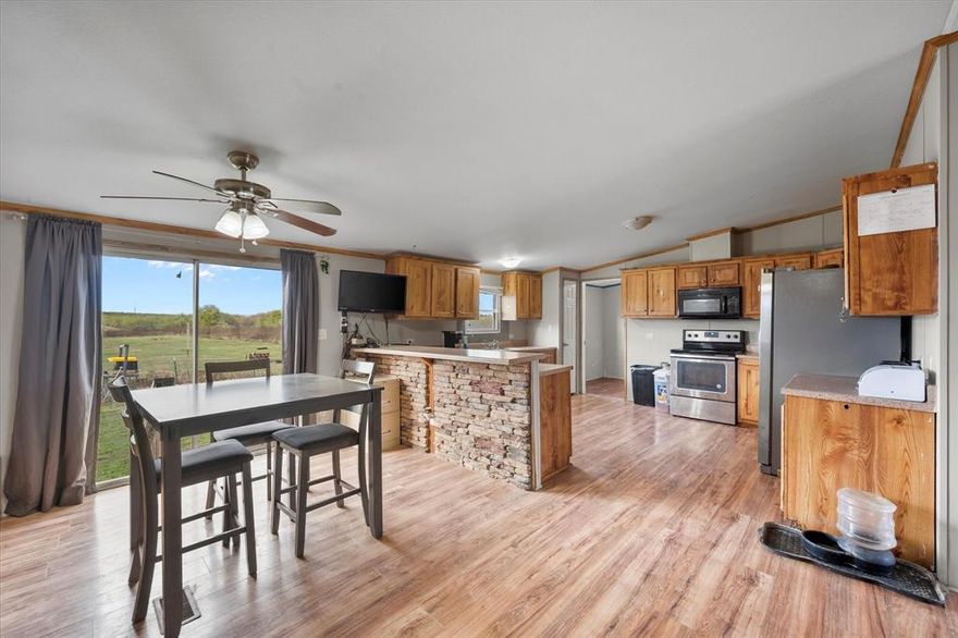 Welcome to your private sanctuary on 13.5 acres of unspoiled beauty! This exceptional property offers a unique blend of freedom and natural wonder, with unrestricted space allowing your imagination to roam as freely as the wildlife that graces the land. Nestled within this picturesque landscape sits a grand double-wide home, boasting 5 bedrooms and 3 bathrooms. The clever design places the other 4 bedrooms at the opposite end of the home, offering privacy and versatility. Two of these bedrooms share a convenient Jack and Jill bathroom, enhancing the functionality of the space.Whether you're looking to embrace the joys of outdoor living, or simply enjoy the peaceful seclusion of your own slice of paradise, this property offers endless possibilities. Seize the opportunity to experience the harmony of nature and modern living. This is not just a property; it's a lifestyle waiting to be embraced. Come and make your dream of countryside living a reality.