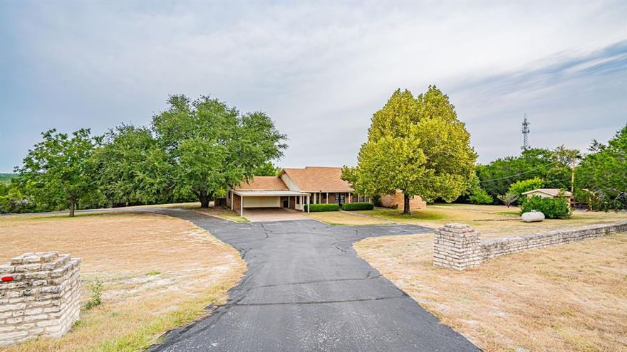 New Listing on 2 Acres! Spacious 3 Bedroom, 3 full bath, study, and formal dining room. Could easily be converted to four bedroom. Large living area with fireplace, spacious kitchen, walk-in closets, oversized garage and oversized carport. Corner tract with circle paved road, huge oak, and pecan trees. Excellent location, close to town and schools.