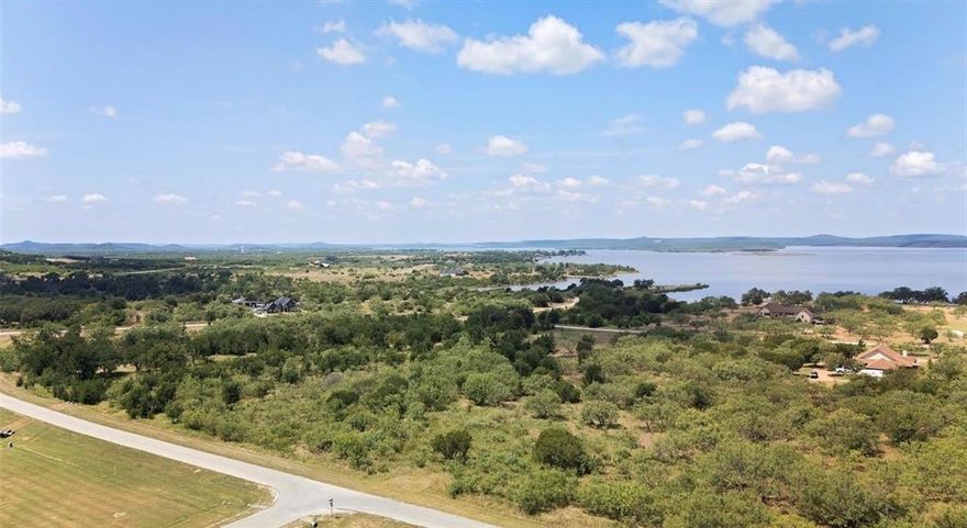 This stunning one+ acre lot in The gated neighborhood of Hills Above Possum Kingdom is the ideal canvas for your dream home. With ample space for a custom-built residence, lush landscaping, and the privacy you desire, this property is truly a rare find. Imagine waking up each day to the breathtaking beauty of your surroundings.

Just a stone's throw away, the community's clubhouse features a fitness center and a stunning infinity pool, offering panoramic views of the lake—this serves as the perfect backdrop for relaxation and socializing. The clubhouse also includes workout facilities and community rooms, providing a vibrant space for residents to connect and stay active.  
As a property owner, you'll enjoy access to an array of exclusive amenities, including Ritchie Cabin, which features a picnic area perfect for outdoor dining and gatherings with family and friends, as well as a convenient boat launch.

Nestled in a picturesque setting on the northern end of the lake, this community boasts rolling hills and endless opportunities for outdoor activities, from hiking to wildlife viewing. Behind the gates, you'll find a peaceful and exclusive living environment, ideal for escaping the hustle and bustle of city life.

Just 15 minutes from town, you can enjoy the best of both worlds: the tranquility of nature and the convenience of urban amenities. Experience PK Lake Life at its finest in this amenity-rich community designed for relaxation and enjoyment. Don’t miss your chance to claim your slice of paradise!
