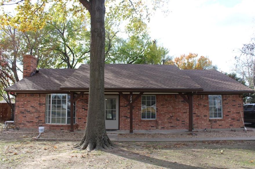 New flooring and paint in this 3 bedroom, 2 bath brick home, near the downtown Crandall area.  Detached garage that could be used as a workshop and has an attached carport. Large fenced in back yard with trees.