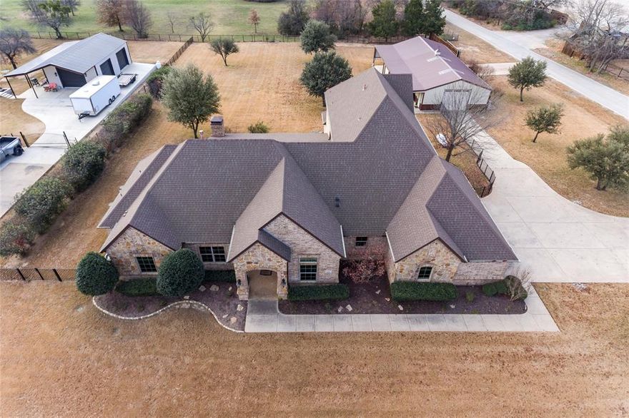 Take a look at the Virtual 360 Tour to appreciate this home! This beautifully crafted brick and stone home offers the perfect blend of space, comfort, and functionality, all set on a sprawling 1-acre lot. Featuring 4 spacious bedrooms and 3 full plus 1 half bathrooms, the home is designed to accommodate both everyday living and entertaining with ease. Three distinct living areas provide flexibility for family gatherings, a home office, or media and game spaces. The updated kitchen and bathrooms showcase modern finishes and thoughtful design, while the oversized laundry room with an attached mudroom adds exceptional convenience and storage. You’ll find abundant closet space throughout, along with extensive storage options to keep everything organized. For added peace of mind, the home includes a family safe shelter. Step outside to enjoy inviting outdoor living areas and a covered patio—perfect for relaxing or hosting guests. Car enthusiasts and hobbyists will appreciate the 3-car garage plus a separate workshop equipped with full electric and HVAC. The property also features covered carport parking ideal for an RV and boat, complete with hookups, making it truly move-in ready for an active lifestyle. This exceptional property offers space, versatility, and amenities rarely found together—an ideal place to call home. Recent updates include full interior and exterior paint, new HVAC system and refinished front door. Whole home water treatment system installed, mini split HVAC system added to the Workshop, backup Generator installed, new septic aerators, new smart irrigation controller. Also, new garage doors with side openers, new side door mount opener for workshop garage. Interior updates include new carpet upstairs, downstairs guest bedroom and primary bedroom. New ceiling fans, lights outlets and switches. New countertops and faucets in Kitchen and bathrooms. Built-in cabinets in Living room, veneer on fireplace, ceiling beams in primary bedroom and more.