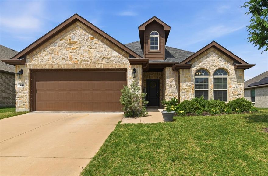 Open-Concept Home with Gorgeous Stone Entry, a Huge Backyard, & oversized kitchen island 

Beautiful 1,699 sq. ft. single-story home featuring 3 bedrooms and 2 baths, highlighted by a striking stone and brick elevation. This open-concept layout offers a warm and inviting living space centered around a cozy gas-log fireplace, complemented by LED lighting and abundant storage throughout.

The chef’s kitchen is designed to impress with an oversized island, granite countertops, stainless steel appliances, subway tile backsplash, and a spacious breakfast bar—perfect for entertaining and everyday living.

Retreat to the spacious primary suite featuring dual granite vanities, a soaking tub, separate shower, and a large walk-in closet with built-ins.

Step outside to enjoy a huge backyard with freshly stained fencing—ideal for relaxing or entertaining with plenty of room to play. Additional highlights include a tankless water heater and a newly installed roof.

This unique floor plan truly sets this home apart—don’t miss it!