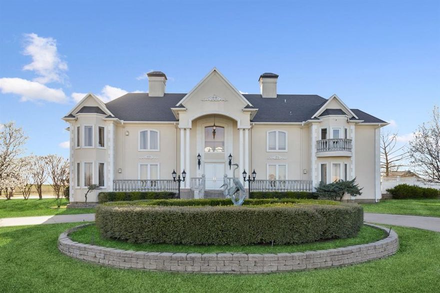 Nestled behind an electric security gate on an expansive 11-acre lot, this breathtaking Georgian-style estate offers unparalleled privacy & elegance in the heart of Gainesville. The backyard is a true retreat, featuring a stunning rock waterfall cascading into a sparkling pool. An expansive patio, complete w-a full outdoor kitchen & bar area, is perfect for year-round entertaining—ideal for hosting guests w-a bartender setup. Dual staircases lead to a serene private retreat. Step inside to a grand entryway w-soaring ceilings & a graceful winding staircase. Formal dining room exudes elegance, boasting a crystal chandelier, custom built-ins & a warming fireplace. A sunlit breakfast room w-double-height ceilings creates a bright & inviting atmosphere. Designed for entertaining, the massive game room features a cozy fireplace, ample space for pool & gaming tables + a wet bar. Generously sized guest bedrooms each include en-suite baths, ensuring comfort & privacy. The chef’s kitchen is beautifully appointed w-an island topped in granite, a built-in refrigerator, an electric cooktop with a vent + plenty of cabinetry. A spacious utility room provides additional storage & room for an extra refrigerator. For added versatility, the home includes a basement—ideal for a wine cellar or a safe haven during Texas storms. The luxurious primary suite is truly impressive, featuring a private sitting area with a fireplace, and a coffee bar. The spa-like en-suite bath includes an oversized walk-in closet. A stately library lined with custom bookshelves adds a refined touch, while an elevator provides easy access to all levels. Additional features include a four-car garage and a 24x32 workshop, perfect for weekend projects. Just steps away, a stocked pond with a dock offers a tranquil escape. With over 9,000 square feet of living space, this estate is not only a dream home but also an incredible investment opportunity—perfect as a luxurious bed and breakfast, wedding venue, or Airbnb.