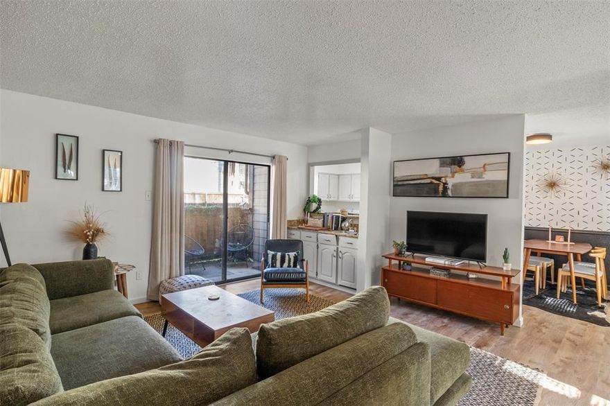 Nestled in a gated community and backing to a lush green space, this super cute first-floor, end-unit condo offers 2 bedrooms and 2 baths with an open, light-filled layout. The living area features a built-in wet bar, electric fireplace, and sliding glass doors that open to a private, fenced patio.
The kitchen is equipped with granite countertops, stainless steel appliances, a built-in pantry, and overlooks both living and dining spaces - perfect for entertaining. Wood-look flooring flows throughout the main living spaces, with plush carpeting in both bedrooms. The spacious primary bedroom includes TWO walk-in closets, while a dedicated laundry room provides ample additional storage space. Unit also comes with 2 assigned parking spaces (one covered) located directly out front.
The affordable HOA dues cover sewer, trash, water, and offer access to a community pool, clubhouse, and tennis courts. Ideally located just off the Dallas North Tollway and close to shopping, dining, and entertainment, this inviting condo truly has it all!