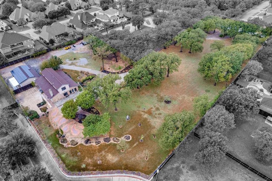 Sitting on nearly three acres, this property gives you the space, privacy, and presence of a true private estate right in Mansfield. The 4-bedroom home underwent a full down-to-the-studs, $250,000 remodel about seven years ago, updating major systems, reworking the layout, and bringing the interior up to today’s standards with quality finishes throughout. With over 3,500 sq ft, the home features generous room sizes, great natural light, updated flooring, and a welcoming main living area centered around a stone fireplace. The kitchen offers plenty of workspace and storage, and even the washer, dryer, and two refrigerators convey with the home for added convenience. Outdoors, the owners invested more than $200,000 in custom paver work, creating multiple patios, walkways, and entertaining spaces that seamlessly connect the house to the land. The acreage is level, usable, and filled with mature trees, giving the property a calm, park-like feel with endless possibilities for expansion—pool, workshop, guest house, or more. Solar panels help reduce utility costs, and while the home feels secluded and tucked away, it remains just minutes from Mansfield schools, shopping, and conveniences. It’s the kind of setting that rarely hits the market: close to everything, yet quietly set apart from it all.