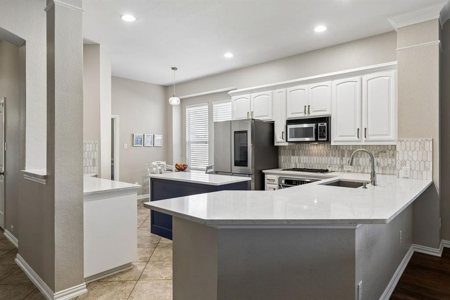 Set in sought-after Aspendale Village in the Stonebridge Ranch Community and zoned for top-rated Frisco ISD schools, this spacious two-story home has it all. One of the only homes with a fifth bedroom, dedicated office, upstairs game room AND dedicated media room, there’s truly space for everyone. The updated kitchen offers custom white cabinetry, quartzite countertops, mosaic backsplash, and a convenient island for additional counter space and storage. In the breakfast nook, you’ll find built-in bench seating to maximize the space and a panty to store all your staples. The kitchen opens to the family room where you’ll find a wall of windows that fill the space with natural light, a recessed built-in bookcase with fireplace and hardwood flooring. In the primary suite there’s another incredible wall of windows, an ensuite bathroom with dual vanities, a separate shower and soaking tub plus a walk-in closet so big you might just throw a dance party. Three additional bedrooms are just down the hall with a conveniently located bathroom that truly maximizes the space. A color-drenched office with French doors for privacy sits at the front of the home and a true formal dining room creates separation from the work and living spaces. Upstairs you’ll discover a huge game room with room for all the toys, a true media room that could also be used as a second office, workout room or studio and the fifth bedroom. The bonus bedroom upstairs has an ensuite bathroom making it the perfect place for overnight guests, older children or even an au pair. The backyard is professionally landscaped with room to roam or in the case of pets, a solid space to get the zoomies out. The covered porch is fabulous, shielded from the sun and primed for an outdoor living area - just add a TV and call it a day.