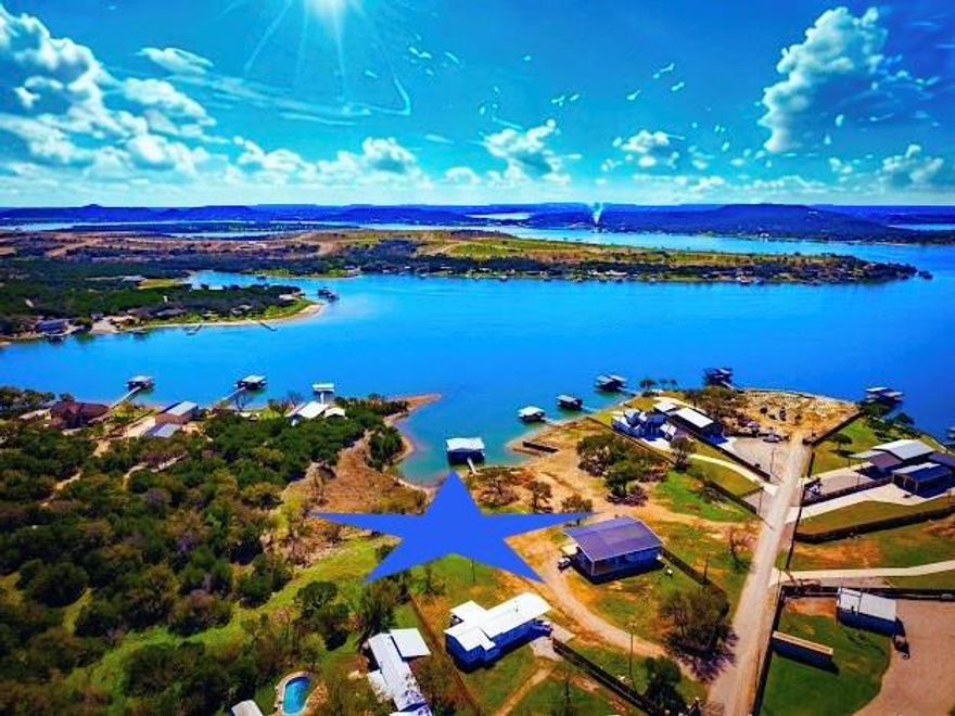 PRIME PK LAKE ESTATE, BUILD LOT with 2.6 ACRES, & ENDLESS POSSIBILITIES with 1000' of SHORELINE, INSULATED 2592 SqFt BARNDO SHOP, DOUBLE LEVEL, 1840 SqFt NEW DOCK, with 2 Boat Slips, 2 Jets Ski EZ Ports, Storage Closet with fresh water Ice Maker, and Lifted Cradle Storage for Water Toys, & 2nd Level has Panoramic Lake Views, plus there is a Concrete Retaining Wall at the shoreline, and Multiple Big View Build Sites for the Main Lake House and BIG extra Acreage for Guest Cabins, Pool, Sports Courts or whatever your PK Dream Family Compound requires. The Barndo features 2 Large Glass Garage Doors, for great Light and Bright Entertaining Space, as well as Boat Storage Space and has a Large Covered Lighted Canopy in Front, and an RV Size Carport on the end with access to Power and Septic, along with 4 RV Parking Sites with Pole Connections and Clean Outs. BE SURE to Check out the Lot Survey in the Photos to see how much Waterfront there is to Build on, with Amazing Elevated Lake Views, as well as pics of the Mature Oak and Cedar Trees throughout the different areas of the property. This is a RARE GEM of a Lake Property that Must Be Seen to be appreciated. Overnight Rentals are allowed. There are 2 great Westside Restaurants nearby by Boat or Car. Fox Hollow and Possum Hollow, and the small Charming Town of Graham is only a 20min drive away for Amenities, Markets and Dining, plus local mercantile shops are only 10mis away. Then the Famous Hell's Gate is a Gorgeous Boat cruise around to the other side of the Lake to watch the Spectacular Sunsets of PK, and then you can stop and dine on the way back at everyone's Favorite Lake Restaurant on the Peninsula, Hemingway's.