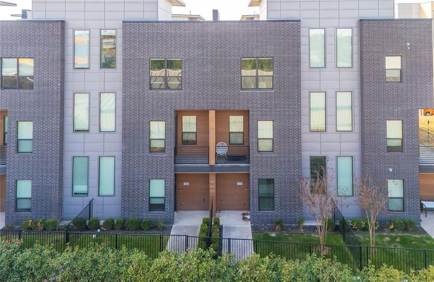Located in the heart of The Cedars neighborhood, this sophisticated row-style condo features an amazing roof top terrance, with 2 car private garage and fully fenced yard, and blends the perfect combination of modern design, luxury finishes, and an unbeatable urban location. Thoughtfully positioned on the back side of the residences, this home offers enhanced privacy and security while keeping you effortlessly connected to downtown Dallas. The kitchen anchors the home with sleek quartz countertops against dark modern cabinets, designer hardware, high-end Samsung appliance package with refrigerator that stays, wine fridge and center island with waterfall edge that creates a seamless flow to the second-floor balcony. The open concept main living area features modern tile fireplace with electric insert ideal for relaxing or entertaining and wall of windows that provide ample natural lighting. The 3rd level features the oversized master retreat with walk in shower, large closet, feature design wall and custom lighting. A 2nd bedroom with private bath can work as a home office! One of the true highlights is your private rooftop terrace, offering partial downtown skyline views—an ideal setting for morning coffee, sunset cocktails, or hosting friends.  Wide staircases, generous walk-in closets, and a built-in central vacuum system add luxury convenience. This home is fully equipped for modern living with smart Nest thermostats, smart appliances, a smart garage door, Ring doorbell, and an integrated security system. An attached two-car garage with direct access and the gated front yard add another layer of privacy and comfort. Located just minutes from Deep Ellum, The Arts District, and Dallas’ top dining and entertainment destinations. The Dallas Farmers Market is less than half a mile away, making weekend outings easy and walkable. With its rare combination of urban energy, thoughtful upgrades, and residential comfort, this home delivers the best of modern Dallas living.