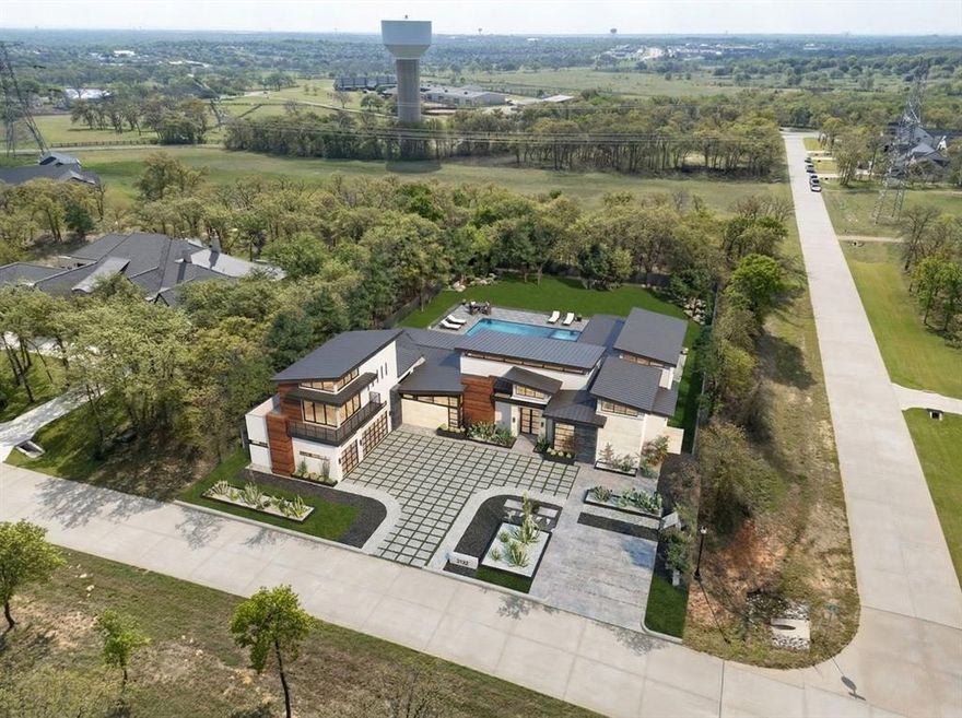 Set on a secluded 2-acre corner lot in sought-after Hat Creek Estates, this exceptional new construction in Bartonville offers the perfect blend of privacy, design, and modern luxury.  Surrounded by mature trees and located within highly regarded Argyle ISD, the setting alone is hard to replicate.

Thoughtfully designed by Oscar E. Flores Design Studio, this single-level home showcases elevated architecture paired with carefully curated, high-end selections throughout.  Every detail has been intentionally considered - from the flow of the floorplan to the finishes that define each space.

The expansive layout is designed for both everyday living and effortless entertaining, featuring open-concept living areas, a chef-inspired kitchen, and seamless indoor-outdoor connectivity. Generous windows invite natural light while framing views of the surrounding trees, enhancing the sense of privacy and tranquility.

This is a rare opportunity to own a fully custom, design-forward home in one of Bartonville’s most desirable communities.  Additional features and finish details are available in MLS or upon request.