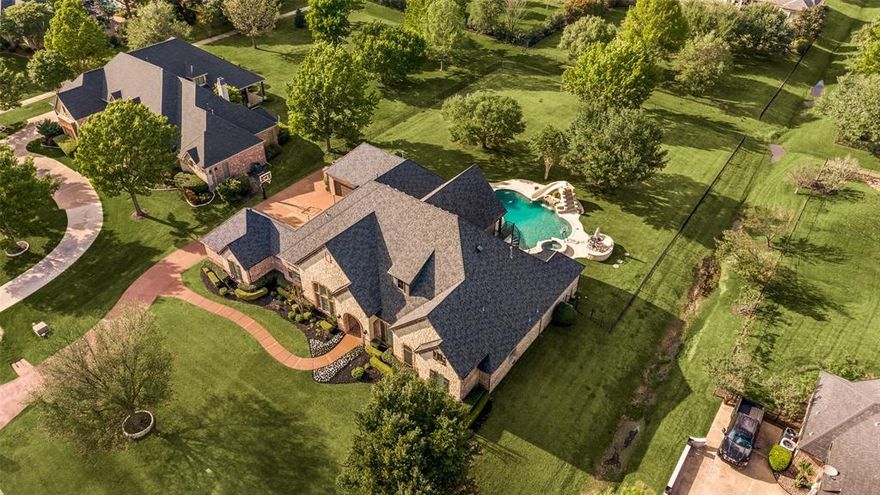 Stunning Dave R. Williams custom POOL home offering 5,412 sqft. on a beautifully landscaped 1.02 acre private lot in the prestigious and highly sought after Whispering Farms neighborhood. From the moment you arrive, the curb appeal is undeniable, lush professional landscaping, custom landscape lighting, an extended driveway with additional parking, and an impressive 4-car garage set the tone for everything inside. The resort-style backyard is an entertainer's dream, centered around a breathtaking 35,000-gallon saltwater pool and expansive outdoor living space designed for relaxation and hosting alike. Inside, soaring ceilings, rich hardwood flooring, built-ins, plantation shutters, and designer finishes throughout, all freshly painted and move-in ready. The primary suite is a true sanctuary, complete with a private flex space ideal for a home office, workout room, or lounge, and a spa-inspired bath with two walk-in closet. The main floor also offers 3 secondary bedrooms, a dedicated exercise room, private office, and a separate laundry room, seamlessly blending luxury with everyday function. Upstairs, the entertainment level is unmatched featuring a massive game room, media room, and a fully equipped bar with beer tap, ice maker, microwave, dishwasher, and sink. A hidden safe room doubles as a second private office, and a full bath completes the upper level. Step out onto the second-story balcony for sweeping views of your backyard paradise. A true masterpiece of design, detail, and luxury living in one of Prosper's most sought-after communities. Prosper ISD and zoned for Walnut Grove HS. Welcome Home!