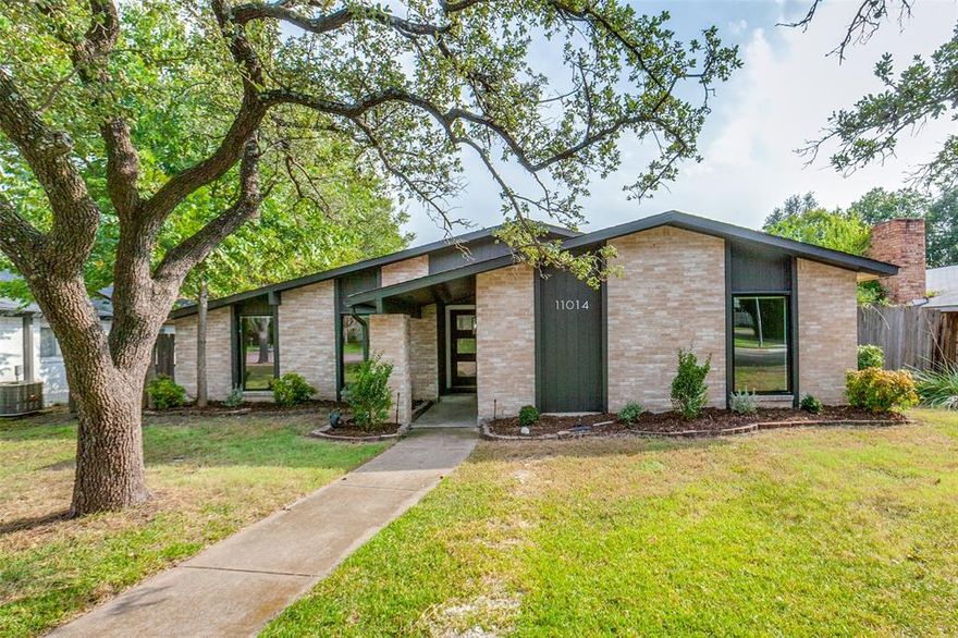 Tucked away in Lake Highlands, 11014 McCree Rd has been fully renovated and pairs classic Lake Highland architecture with an elegant style highlighted by the use of clean lines and natural materials. 
Generously sized, airy living rooms accompanied by three bedrooms all unified by new warm flooring throughout the home. The well appointed kitchen anchors the intentional layout. An oversized picture window and glass sliding door provide natural light and an unobstructed view to the covered patio and fenced-in backyard. The kitchen extends into the second living area with a mid-century brick fireplace inside that invites cozy nights in. The private primary includes a spa-style ensuite bath and a double vanity.  Located within the Richardson Independent school district 11014 McCree is a Lake Highlands renovation that feels polished and natural.