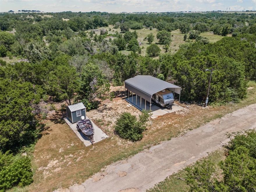 Vacation or weekend property located in the lakefront community of Lake Granbury Harbor. This property features two RV slabs, each with individual 50-amp hookups and water ideal for hosting guests or expanding your setup. One RV slab has an RV carport and the storage shed will convey with the sale. Property backs up to a large ranch for additional privacy. Residents of Lake Granbury Harbor enjoy access to Lake Granbury, a community pool, and park. Whether you're looking for a private retreat or weekender, this property is ready for you.