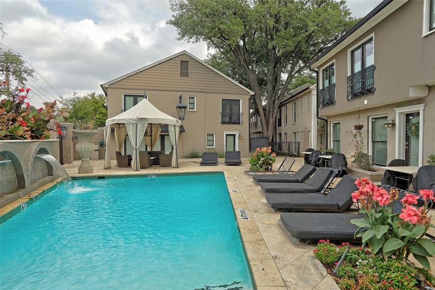 Two private outdoor spaces, a full-size patio for dining and grilling, and pool access just outside your door — this first-floor home at Paradiso doesn't live like a condo.

What sets this unit apart is the outdoor space. A private, fenced front courtyard gives you a separate entry feel with room for seating and plants. Out back, a full-size patio fits a dining table, grill, and lounge chairs — all behind privacy fencing. For a condo, this is rare.

Inside, the living and dining areas flow together across hardwood floors with crown molding overhead and natural light from multiple exposures. The kitchen features granite counters, white cabinetry, and a breakfast bar that opens to the main living space without closing anything off.

Three bedrooms give you real flexibility. The primary suite has its own dressing area, generous vanity, and walk-in tile shower. A second bedroom works equally well as a guest room or home office, and a third adds good closet space. The second full bath — with a jetted soaking tub — serves the rest of the unit.

Paradiso is a gated community minutes from NorthPark Center, Central Market, and the full run of restaurants and shops along Lovers Lane and Greenville Ave. Two assigned covered parking spots included.