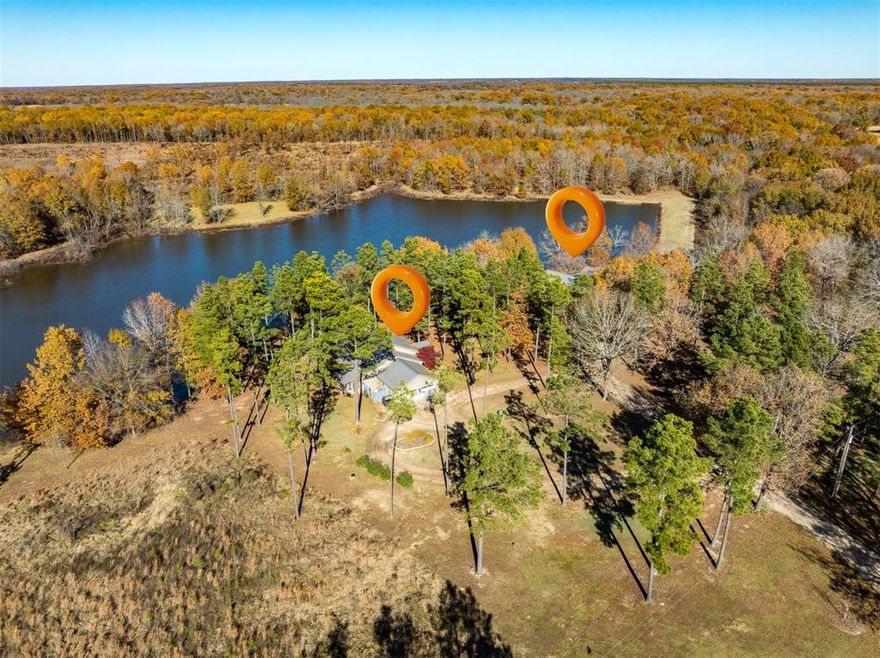 A perfect blend of natural beauty and opportunity combines on this sprawling 745.78 acre property known as Russell's Cuthand Creek Ranch, in the northernmost part of the Piney Woods of East Texas. Located in Clarksville, the county seat of Red River County, this incredible property features a diverse landscape of timber, pastureland, wetlands, multiple ponds, creek & a lake with 2 piers. Encompassing 360 acres of wetlands within the Wetland Reserve Program, this land offers an ideal habitat for exotic game, hybrid deer, buffalo, and more. Trails wind through the wetlands for recreation & ease of maintenance. Enhancing the appeal of this property is an exceptional rustic two story stone & cedar lodge overlooking the well-stocked lake, with approximately 3820 sq. ft., 4 bedrooms, 2.5 baths, an expansive living area with vaulted beamed wood ceiling and walls and soaring stone fireplace. Living area opens to upstairs loft, dining & spacious kitchen with island. Enjoy upper level with 2nd living area with fireplace, 2 bdrms, bath, bonus room & loft (sleeps 4). In addition, there is a single family custom built home with approximately 1750 sq. ft., 1 bedroom, 1 bath (with tub & shower sauna), with open living(vaulted ceiling), dining, kitchen (complete with island, pantry, & built-in Thermador refrigerator, freezer plus wine refrigerator) & office. A combo laundry & exercise room plus screened porch & picturesque tree shaded lakeside patio complete this home. The 1,200 sq.ft. insulated shop, complete with a 300 sq. ft. porch, two overhead doors, concrete flooring, kitchen, bath, storage, and potential living space— is ideal for customization to suit your needs. Additionally, equestrian enthusiasts will appreciate the barn, with a tack room & five stalls. A covered shed provides storage for farm & ranch equipment. This exceptional property offers a unique opportunity to embrace a lifestyle surrounded by nature, providing peace, privacy and endless possibilities!