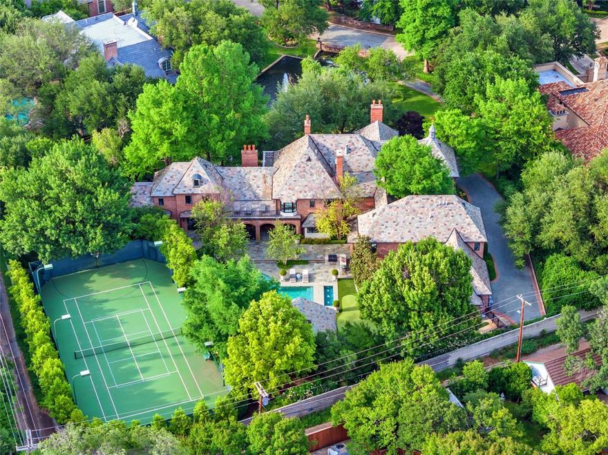 Set on an elevated 1.24-acre lot (where the original Murchison estate resided) within the ultra-private, gated and guarded community of Los Arboles, this Hamptons-inspired estate originally designed by Wilson Fuqua was completely transformed via a to-the-studs remodel circa 2017 by MORE Design + Build, by lead designer, Chad Dorsey, into a fresh vision of luxury. This exclusive enclave of just 31 estate homes is a hidden gem in Preston Hollow. With tree-lined streets, peaceful ponds, and a resort-like atmosphere, it’s hard to believe you’re only minutes from Dallas’ top private schools, luxury shopping, and world-class dining. The thoughtful floor plan seamlessly blends modern amenities with comfortable living. Six primary-sized bedrooms and nine baths unfold across five distinct living areas. The open-concept kitchen and family room serve as the heart of the home, with custom cabinetry, an incredible separate prep area with pocket doors, and sliding glass doors that open completely to your backyard oasis. Multiple access points lead to private balconies and outdoor living areas blurring the line between indoors and out. On the main level, you’ll find elevated designed spaces: a home office, media room, gym, and a moody speakeasy-style bar that is featured in Dorsey’s recent book, Relaxed Luxury. Just above a private guest suite with private entrance and balcony offer privacy for long-term guests. Upstairs, the primary suite feels like a private escape with a serene balcony overlooking the pond, dual walk-in closets, and a marble-wrapped bathroom. Four additional unique oversized en suite bedrooms round out the thoughtfully designed second floor. Outdoor living areas boasts a covered pavilion with a fireplace, separate screened in patio, a regulation lighted tennis court, putting green, pool and spa. This property features a 4-car garage with port cochere and additional parking pads for one of the best off-street parking arrangements in the development.