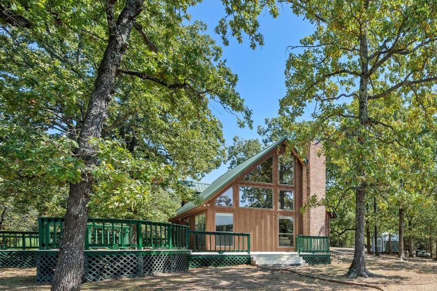 Welcome to a one-of-a-kind property, offering the tranquility of a remote lakeside retreat coupled with immediate access to city amenities. The entryway invites guests and loved ones into a stunning living area, bathed in natural light, with a majestic stone fireplace and breathtaking views of the shimmering lake. The kitchen, open to living, includes ample storage, a two-basin sink, and a pass-through bar. Upstairs, a delightful loft area overlooks the living room and offers even more amazing vistas. The primary bedroom is spacious, with a vaulted ceiling, en suite bath, and an immense walk-in closet with built-ins. Outside, enjoy an expansive, wrap-around deck, a shaded concrete patio, a terraced garden bed, a newly added storage shed, and more. On over half an acre of wooded waterfront and situated at the end of a secluded, tree-lined approach, this home boasts a unique combination of privacy & pristine natural beauty, all conveniently 10 minutes from downtown Paris, Texas! Schedule your home tour today!