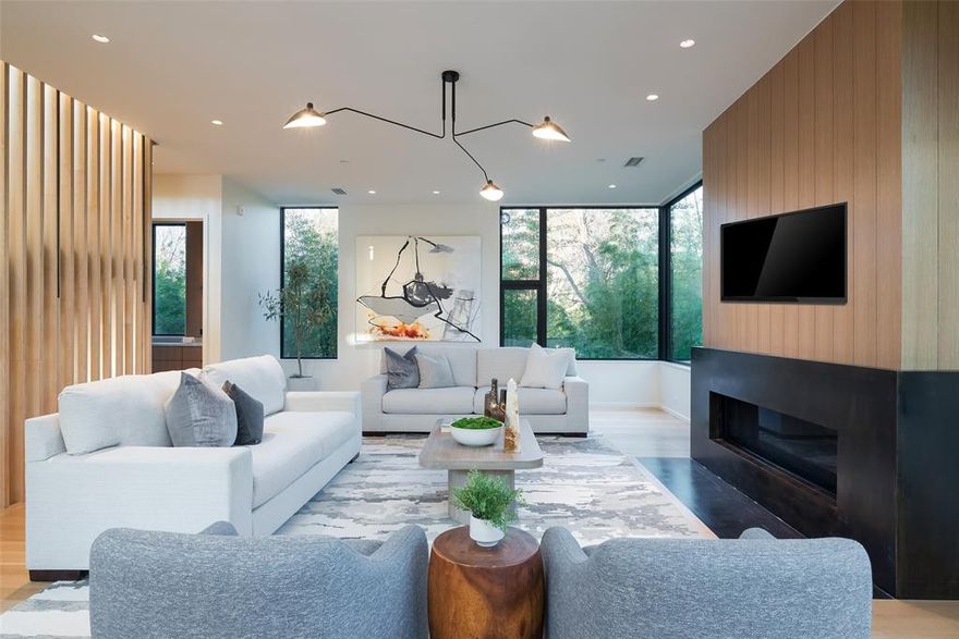 One of the finest properties on the Katy Trail, this Cunningham Architects design offers everything the discerning buyer would want. One of two free standing custom treehouses with over 50 feet of wooded frontage along the trail, the gated property offers unique privacy and access in one the city’s most dynamic pedestrian friendly corridors. Adjacent to Knox Street, Highland Park and Turtle Creek, and landscaped by Hocker Design, 3503 checks all the boxes for a sophisticated low maintenance, lock and leave lifestyle. On a pier and beam foundation and with a standing seam metal roof, the finest materials were chosen including wide plank white oak flooring, riff cut oak millwork and top-of-the-line appliances such as Sub Zero & Wolf. On three spacious levels, each with elevator access, the first floor has an elegant entry, a guest suite with an ensuite bath and an open living area viewing a garden. The second level is all generous living space with filtered light streaming from all directions through the lushly planted setting. A living room sized balcony overlooks the Katy Trail. Ceilings are tall and windows are large to take in the beauty and the privacy of the property’s wooded surroundings. A sculpturally detailed, see-through, oak framed staircase divides the living area from the dining room and kitchen. The kitchen has all the bells and whistles, including an island for dining, and a walk-in pantry. The kitchen is finished with Quartzite countertops and opens to a balcony for outdoor grilling. On the third floor is the primary bedroom suite with wonderful vistas of the Trail. The primary bath has a separate tub and shower, and oak finished storage and closet space. The home’s third bedroom is also on this level and has its own ensuite bath.