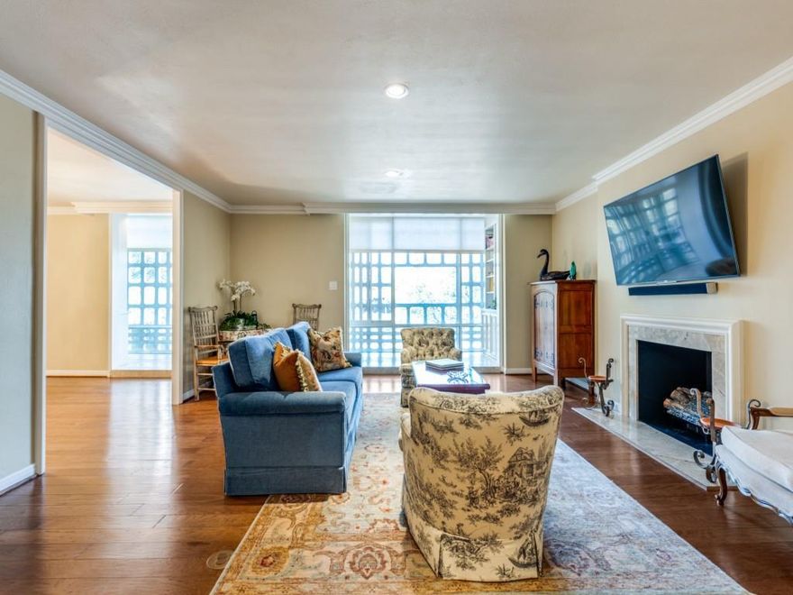 Discover timeless elegance in this iconic Turtle Creek residence, designed by Howard Meyer and listed on the National Registry of Historic Places. Enter through custom doors into a private foyer, setting the tone for this sophisticated home.

The living and dining areas feature wood floors, an electric fireplace, and floor-to-ceiling windows, with a full-length sunroom creating a versatile retreat. The kitchen honors its mid-century roots with original metal cabinets, paired with a Dacor stainless steel oven, induction cooktop, and stainless steel refrigerator.

The primary suite offers an en-suite bath and cedar closet, while the second bedroom features built-ins overlooking the oval pool and a stunning magnolia tree. Both bathrooms are fully remodeled with modern finishes. Additional highlights include built-in bookshelves, private basement storage, and two assigned garage parking spaces.

The building's iconic brise soleil filters the Texas sun with mid-century charm. Residents enjoy 24-hour valet and concierge service, a guest suite, fitness center, conference room, and the legendary Turtle Room with catering kitchen. The shaded oval pool and outdoor grill patio complete this resort-style lifestyle.

Minutes from Katy Trail, Kalita Humphries Theatre, and the dining and shopping of Uptown, Oak Lawn, Knox District, Arts District — this is lock-and-leave luxury at its finest.

HOA covers all utilities including internet; building amenities are plentiful, including 24-hour concierge and valet, fully furnished guest suite, pool, gym and club room with full catering kitchen.