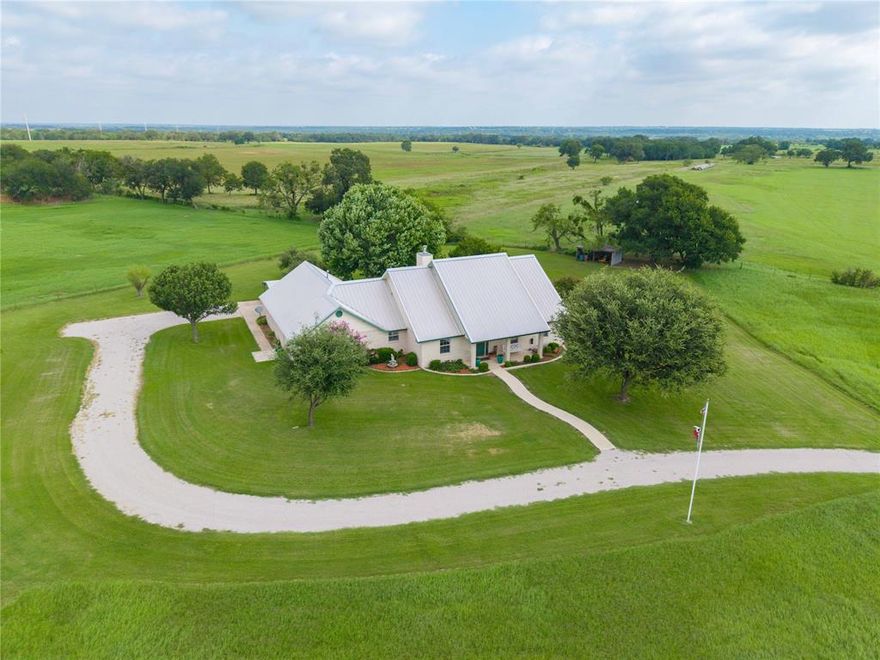 AMAZING PRICE IMPROVEMENT! Set back for privacy this Elegant 2709 square foot home has 3 bedrooms. 2 full bathrooms and a half bath. Let's talk about entertaining! Beautiful high ceilings with crown molding in this grand living room with a wood burning stove for that cozy feel. PLANTATION SHUTTERS THROUGHOUT!  The private dining room is ideal for family and friends at the holidays. There is enough room in the kitchen for everyone to help with the holiday baking. The breakfast nook and bar with bar stools provide extra sitting. The bedrooms have custom closets. The primary ensuite has a soaker tub, spacious walk in shower, separate vanities and his and her closets! A private office for working from home. The entrance to this Beautiful home leads you through lush grass and beautiful trees to double covered parking. The backyard is cross fenced which is perfect for children and pets. Enjoy the sunrise from your front covered porch and take in the sunset from your large covered back porch. There is a well that is run by a wind mill which feeds the pond. Bring your horses and FFA projects. This Beautiful home has been lovingly taken care of. Hurry and make this your forever home!  Call today and not miss the chance to own this rare beauty!!