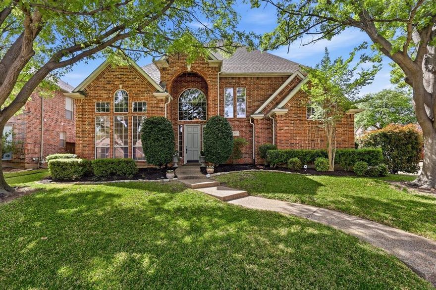 Welcome to 117 Portside Drive, a standout home in the heart of Coppell where timeless elegance, thoughtful upgrades & exceptional outdoor living come together beautifully. From the moment you arrive, the superb corner lot location, mature trees & manicured landscaping create unforgettable curb appeal.
Inside, 20 foot soaring ceilings, rich hand scraped hardwood floors, plantation shutters, abundant natural light & striking architectural details make an immediate impression. The layout offers the perfect balance of sophistication & comfort, featuring a dramatic entry, formal dining, 3 living areas &  1st level primary suite . The kitchen is both beautiful & functional with granite countertops, generous cabinetry , walkin pantry, Bosch dishwasher & a touch kitchen faucet. Kitchen opens seamlessly to the breakfast & living spaces for easy everyday living & entertaining. 
The private primary suite is a peaceful retreat with a spacious bath offering dual vanities, soaking jetted tub, separate shower, and nice walk in closet plus a cedar closet. Upstairs, oversized secondary bedrooms all with walk in closets. 3 of the bedrooms have window seats with storage. A large flex space provides room for a game room, media room, playroom, or home office. Additional upgrades include Toto high-volume toilets, hybrid resilient wood plank flooring in closet  & an energy efficient attic radiant barrier.
The backyard is a true showpiece with a private sparkling pool, spa, patio seating area, half-court basketball setup & Gorilla goal. Long lasting Trex type fencing & an electric rear privacy gate add privacy & convenience. SafeRacks ceiling storage in the garage & timer-controlled front porch & exterior lighting add even more everyday function.
117 Portside Dr offers a rare blend of comfort, style & resort style outdoor living in one of Coppell’s most desirable locations. Across the street from gorgeous canals. Convenient to schools, shopping, dining, highways & DFW airport.