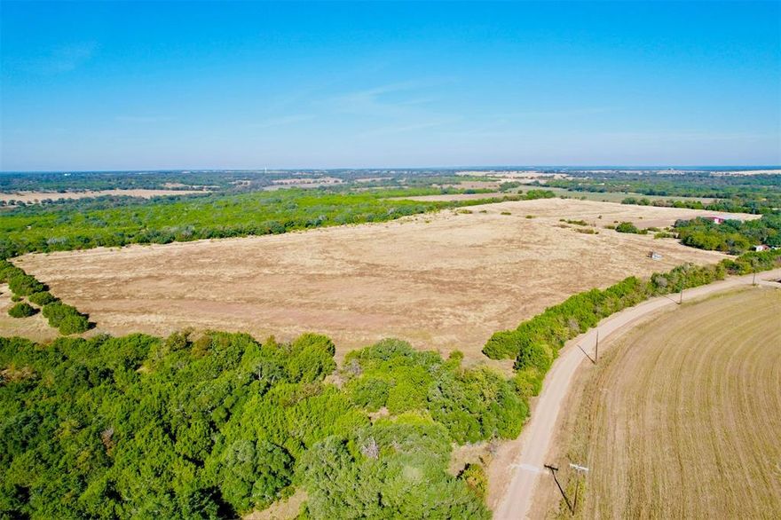 80 MOL acres located just outside of The Grove, TX. Rectangular tract with great paved county road frontage. Productive soil that is great for agricultural production. Several neighboring tracts are heavy timber, making this a property that is attractive for hunting even though it is mostly open. There are a few small timber pockets along fence rows, and one 8-10 acre timber pocket on the front of the property. There are 2 homes on this property. A 2 bed 1 bath ranch style home, and a 3 bed 1 bath barndominium. According to the seller more water meters would be available with a water line upgrade.