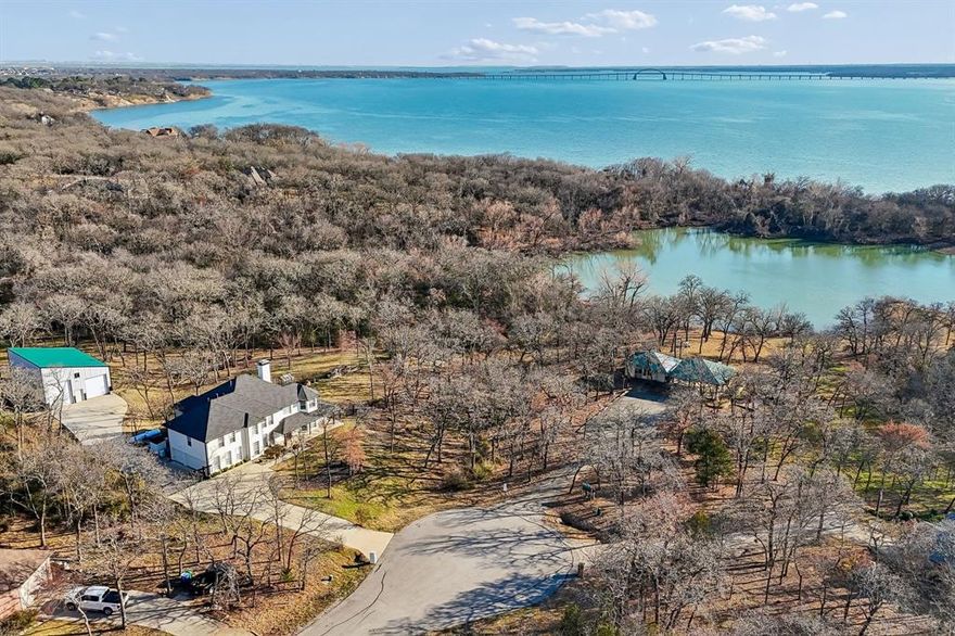 Have you beenon the hunt for a luxury waterfront home that offers warmth and character while still feeling like a second home escape? Allow me to introduce you to 840 Lake Park Drive.  Come take in water views, GORGEOUS sunsets a dreamy opportunity to vacation where you live.  Nestled on just over an acre at the bottom of the cul-de-sac this 4025 square foot beauty with fresh exterior paint and electronic rod iron gate not only offers fabulous curb appeal - we truly think it will sweep you away.  Thoughtfully remodeled in 2019 you will find 5 generous bedrooms - Light and bright kitchen with window encased eat in dining - a secondary bedroom with bath adjacent, step down wet bar, enormous out door deck with hot tub and an incredible downstairs office with additional storage area. Upstairs is a loft or second family room with fireplace and balcony access to enjoy the beauty of the lot and WATER.  The expansive Primary Bedroom is positioned on second floor to maximize views - but fear not- the beautiful Stilz home lift elevator installed in November of 22 makes the property fully accessible. Also sitting on this truly extraordinary piece of property is a well done fully insulated shop-garage with electric roller doors that can safely and easily hold your RV and boat and there is also a little Greenhouse with electric and water! Oak Point boat ramp is conveniently located nearby for you to enjoy game changing recreation on Lake Lewisville.   Other important improvements worth noting : 1000 Gallon Propane tank, 24KW propane generator, 60 amp breaker and whole home surge protector.  Please come visit, we think its a very special property that truly must be walked to appreciate.