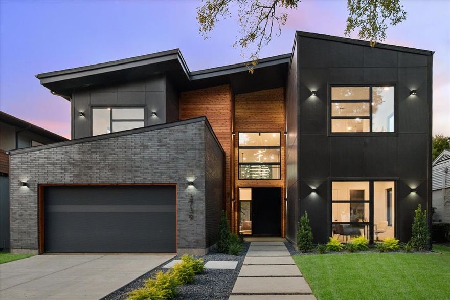 Exquisite modern contemporary home in sought-after Midway Hollow, 3739 Rockdale Drive offers 4,006 square feet of cutting-edge design and refined living. Soaring 20+ foot vaulted ceilings and White Oak hardwood floors set the tone for the open-concept layout, centered around a dramatic gas fireplace. The chef-inspired kitchen is a true showpiece with quartz countertops, an oversized island, 48-inch range, pot filler, microwave drawer, wine cooler, custom cabinetry, walk-in pantry, and a connected utility–butler’s pantry with additional counter space, sink, and storage. The main level boasts a luxurious owner’s suite with a spa-like bath featuring a freestanding tub, dual shower with rainfall head, 2 floating vanities with ambient under cabinet lighting, and an expansive walk-in closet with center island, plus a guest suite  that can be used as office and powder room. Upstairs, three bedrooms with en-suite access complement a versatile open living room with sliding doors to a covered balcony overlooking the backyard. Smart technology, designer lighting, a tankless water heater, and energy-efficient spray foam insulation complete this exceptional home, where every detail has been thoughtfully crafted for modern luxury.