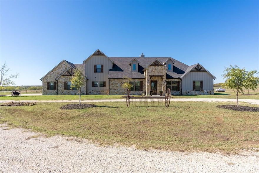 Built in 2019, this breathtaking estate redefines country living with its 4,353sf exquisite main house, 750sf 1.1 barndominium, a total of 5,103sf. Nestled on 30 sprawling acres, this property embodies a blend of contemporary elegance and pastoral tranquility. A chef's dream kitchen with dual quartzite islands, custom cabinets, & sleek modern amenities. A see-through fireplace with Austin stone beautifully separates the kitchen from the living room. Soaring vaulted ceilings create an atmosphere of grandeur throughout the residence. The master bedroom offers views of the pond. Spa like master ensuite boasts a spacious shower w a rain faucet, a freestanding tub to indulge in, double vanities & large custom closet. 4 addl barns with working pens, all fully fenced with 2 entrances. Tranquil stockpond that adds to the versatility of the property. Whether you seek a spacious family home, or the opportunity for agricultural or equine pursuits, this estate has it all. Owner financing available
