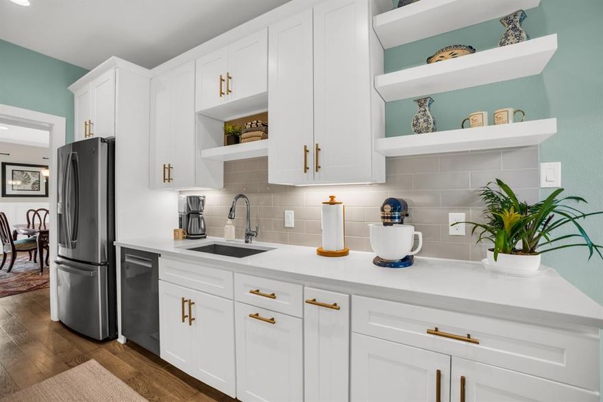 Extensively updated and thoughtfully redesigned, this first-floor condo in the gated 5800 Royal Lane community offers true lock and leave living in the heart of Preston Hollow. Over $33,000 in improvements since August 2023—plus rebuilt down-to-the-studs out in 2021—means the work has already been done for you. Rebuilt with NEW electrical, plumbing, HVAC, and more, the interior blends modern finishes with everyday comfort. Hardwood floors run throughout, complemented by recessed lighting, custom board batten molding in the dining area, and a fireplace that anchors the living space. Glass French doors open directly to the pool, creating an easy indoor-outdoor connection. The gourmet kitchen features quartz countertops, a premium induction cooktop, Frigidaire Gallery appliances, motion sensing faucet, and access to a second private patio, ideal for morning coffee or evening wind-down time. The primary suite includes a fully reimagined bath with raised shower ceiling, added shower lighting, Schluter waterproofing system, frameless glass enclosure, Carrara marble flooring, oversized walk-in closet, and direct access to a fenced private patio with Deckorators Voyage mineral-based composite decking. The guest bath offers quartz counters, motion sensing faucet, tile flooring, and a spacious walk-in shower. Neutral paint throughout adds a clean, cohesive feel. The HOA covers all utilities, electricity, water, sewer, trash, cable, as well as the HVAC system and building maintenance, simplifying ownership. Conveniently located near premier shopping, dining, and major Dallas corridors.