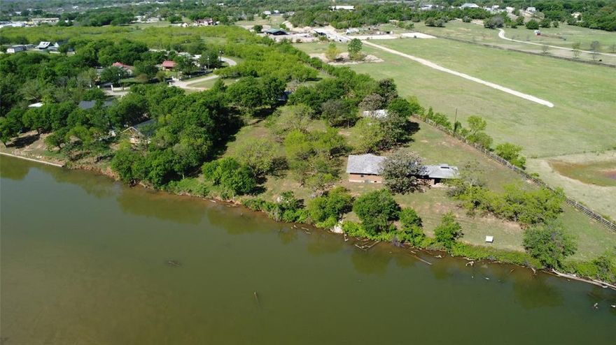 Amazing lakefront opportunity! A total of 20 acres on Lake Granbury with 230 feet of main body shoreline. The possibilities are endless as one can build the perfect lake house and still have plenty of room for the horses or other animals. The kids can enjoy fishing and four wheeling all on the same property! Or maybe you are a developer looking for a truly unique opportunity. Either way this land is ready for whatever you can dream up. Just minutes from historic downtown Granbury. A boat ramp and park are conveniiently located across the street. There is a well on site and a co-op water line runs along the south end of the property. This one is special! Let us go show you this gem today!