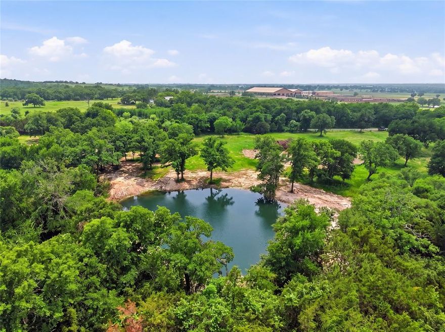 Discover this rare 11-acre gem in NW Parker Co, TX, a true standout property nestled in the heart of one of the most sought-after equine communities in the region. This picturesque parcel fronts directly on both Hwy 52 & Manley Ln, offering excellent accessibility while maintaining a peaceful, private setting surrounded by large est horse properties & ranches. Completely fenced for security & immed livestock use, the land features rich sandy loam that is ideally suited for establishing or expanding improved pastures & grasses. Whether you're envisioning a productive hay operation, training arena, or simply lush grazing areas for horses or other livestock, the fertile ground & favorable topography make it exceptionally versatile. A spring-fed pond stocked with fish sits at the heart of the property, perfect for relaxing or fishing. Towering hardwood trees, including magnificent post oaks & live oaks, blanket the ac. These stunning, mature specimens not only provide abundant shade & year-round beauty but also create natural privacy screens & windbreaks, giving the new owner a secluded sanctuary feel amid the rolling TX countryside with the perfect canvas to build your dream home.  It also offers outstanding potential for a premier equine property, imagine building a spacious barndo with horse stalls, a covered arena, & expansive pastures tailored to your equestrian lifestyle. Its peaceful loc. & natural amenities also make it an ideal weekend getaway or private retreat, where you can escape the city & enjoy country living at its finest. Properties of this quality, size, & character complete with mature timber, water features, fertile soil, direct road frontage, & prime positioning in an established equine neighborhood are increasingly difficult to find in Parker County. Convenient proximity to Weatherford, FtW & major highways, yet far enough from the hustle to enjoy true serenity, this legacy property offers endless possibilities while honoring its natural strengths.