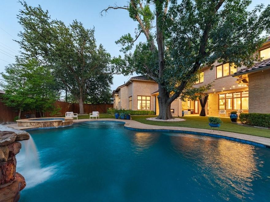 Nestled in the coveted heart of Preston Hollow, 6507 Lupton Drive is a 6,300-square-foot Spanish-style masterpiece that seamlessly blends timeless architecture with a sophisticated, resort-like lifestyle.
Behind its freshly painted façade and impeccable landscaping, you’ll find five spacious bedrooms and five-and-a-half baths, a private study, and an open-concept kitchen designed for culinary artistry and effortless entertaining. Sun-filled living and dining areas feature graceful archways and rich finishes that celebrate the warmth of Spanish design.
Step outside to a luxurious backyard retreat where a covered outdoor living area with a stone fireplace invites year-round gatherings. The sparkling pool, complete with water feature, and expansive patios create the perfect setting for outdoor entertaining.